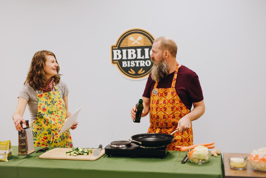 Two cooks demonstrate a recipe as part of Biblio Bistro