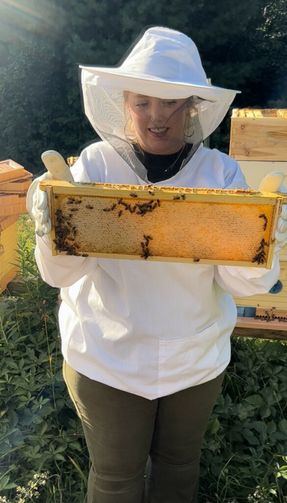 The author, Lily Venable, at Copper Country Beekeeping Club's Tom Rosemurgy's hives