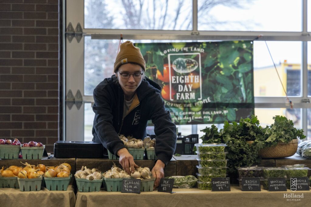 Eighth Day Farm sets up shop at the Holland Farmers Market with garlic, microgreens and kale.