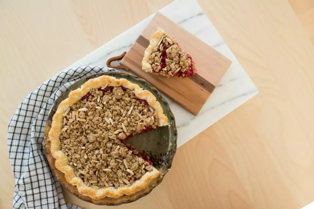 Michigan Tart Cherry Pie with a slice out, using an almond oatmeal streusel crumble as the topping